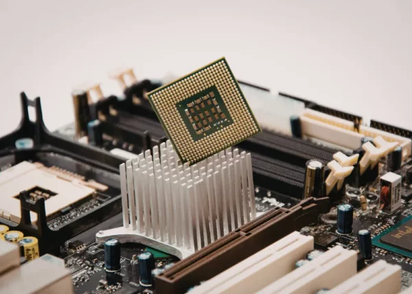 Close-up of CPU chip above aluminum heat sink on motherboard demonstrating electronic component cooling and thermal management