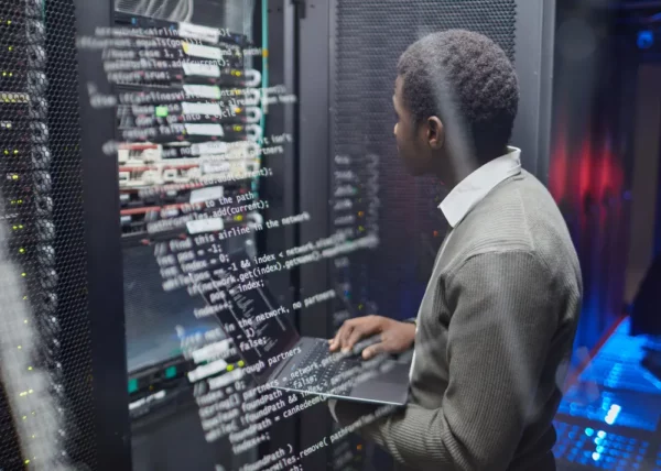 Technician working in data center server racks illustrating thermal management and cooling systems for high-performance computing