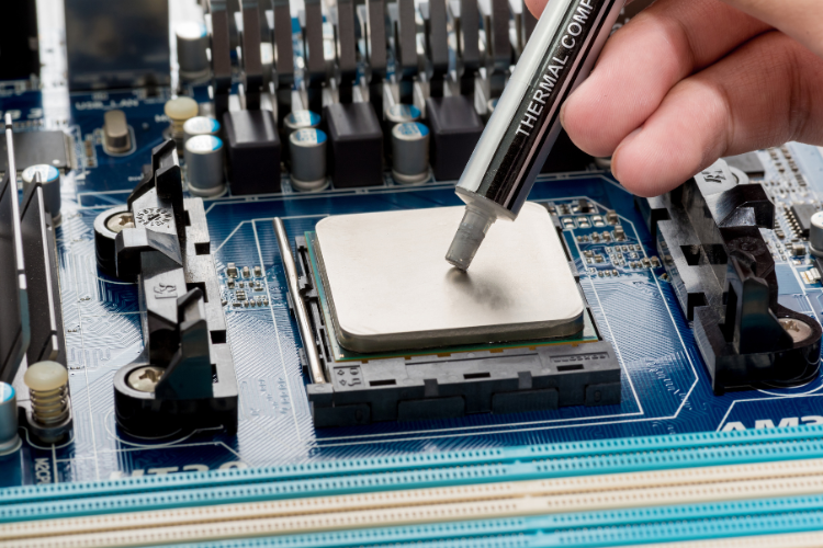 Thermal compound being applied to a processor to reduce thermal resistance in electronic systems.
